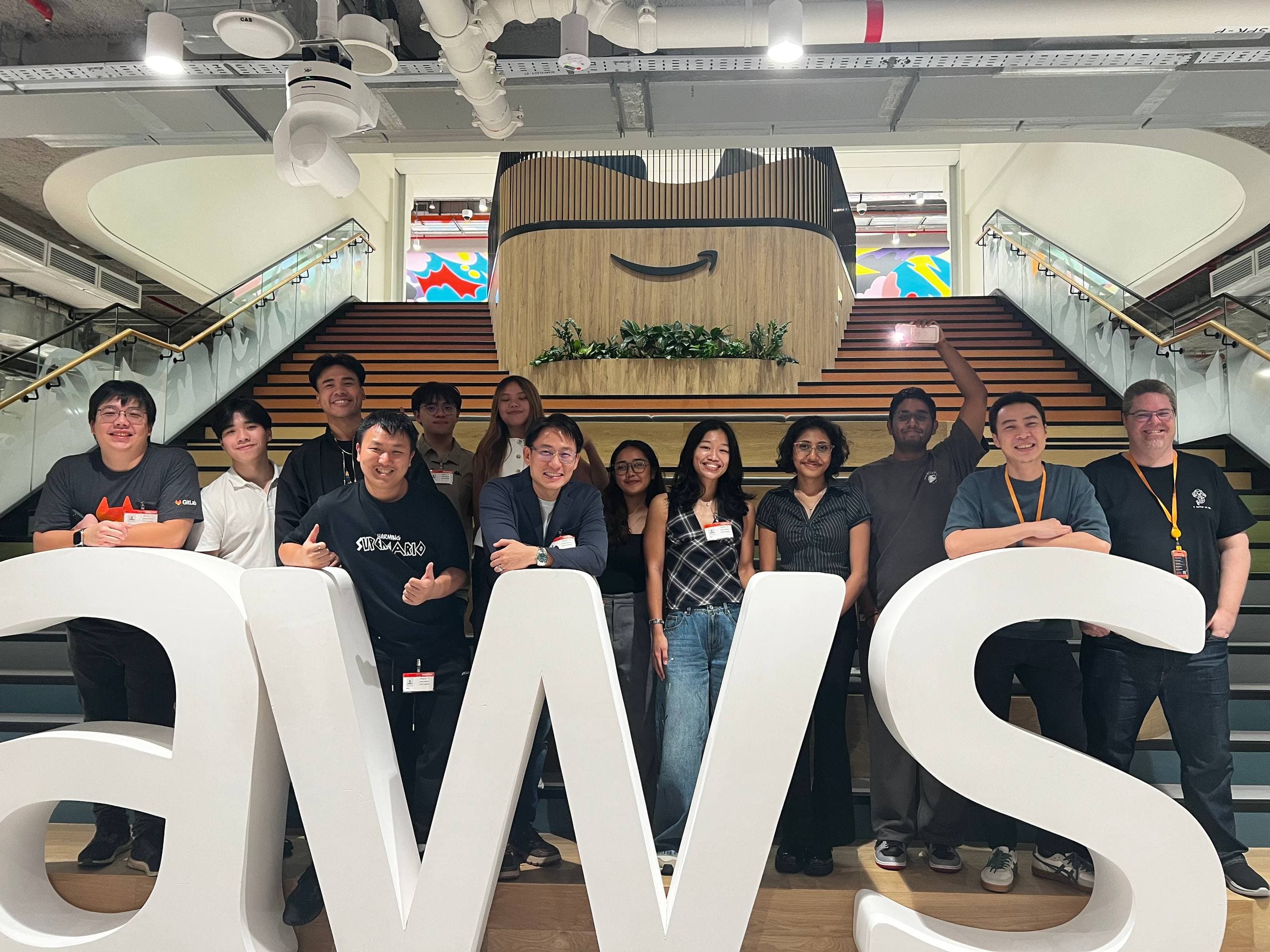 GitLab and student community organisers posing together at the AWS office
